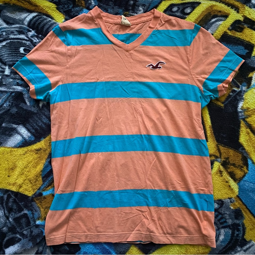 This is a peach and blue Hollister shirt. It is a like new condition shirt.